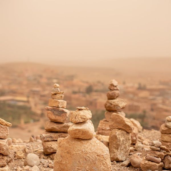 A serene landscape with stacked stones symbolizing balance and philosophy.