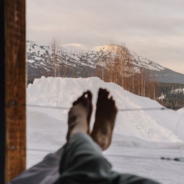 Person stretching energetically during sunrise, feeling refreshed.